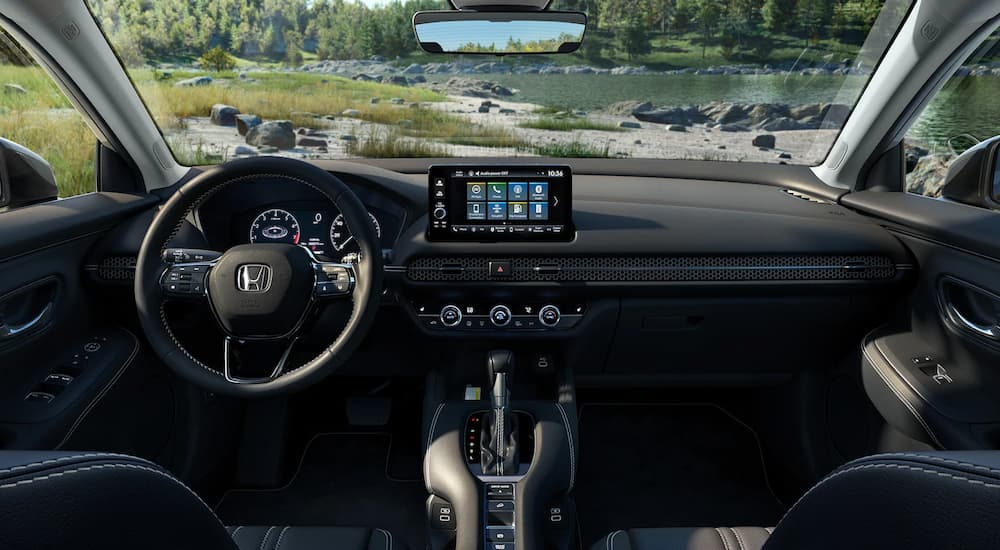 The cabin of a 2025 Honda HR-V EX-L parked near water.