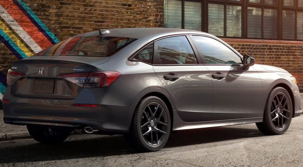 A gray 2026 Honda Civic parked near a painted wall.