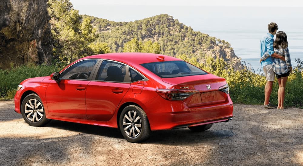 Red 2026 Honda Civic parked near a hiking trail