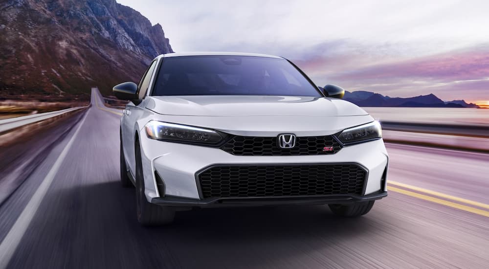 White 2026 Honda Civic Si driving on a highway