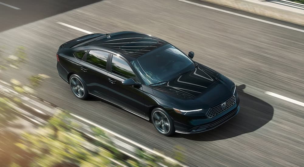 Black 2026 Honda Accord Hybrid driving on a highway