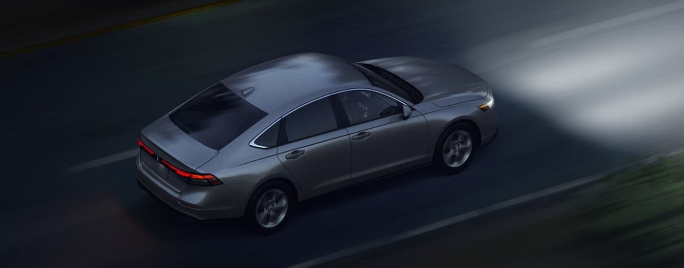 Grey 2026 Honda Accord driving on a highway at night
