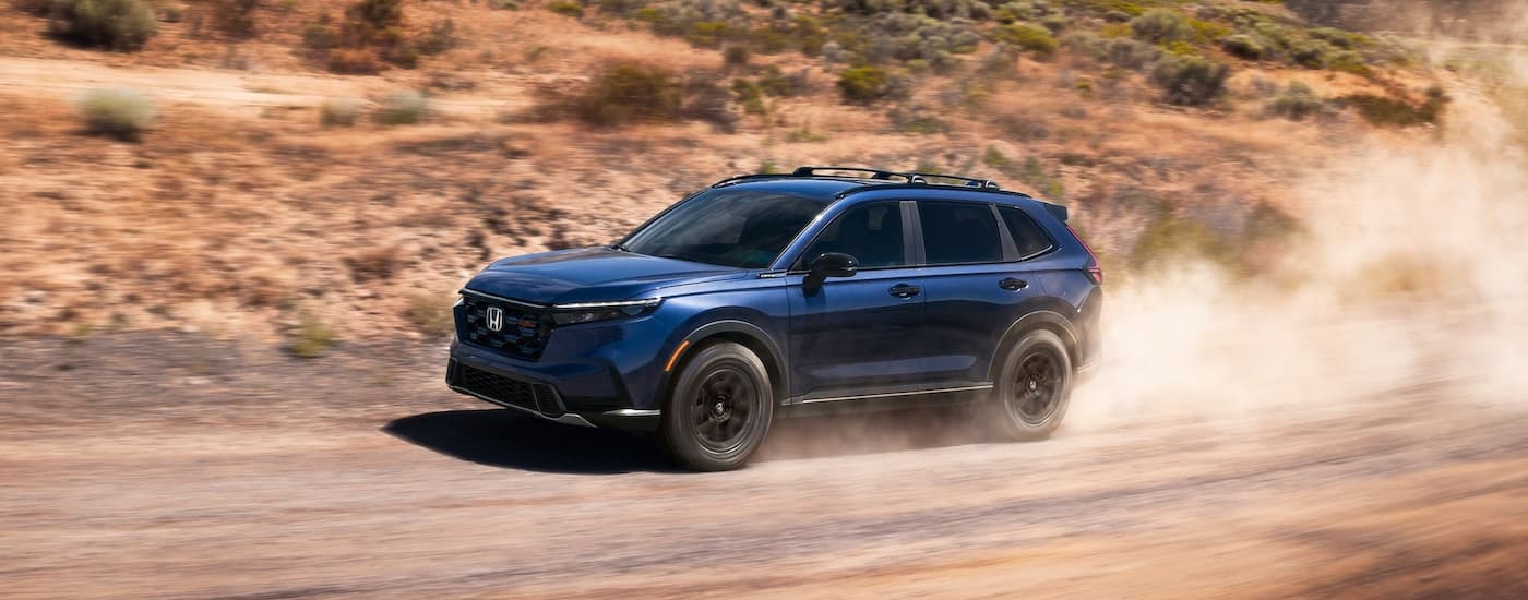 Blue 2026 Honda CR-V driving off-road.