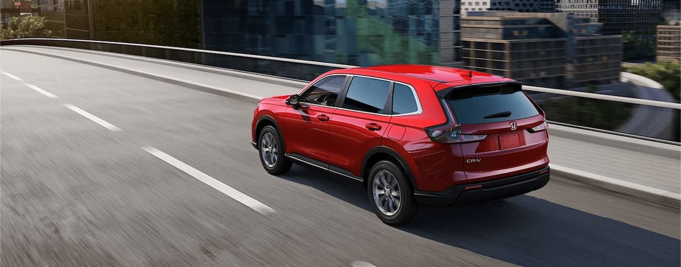 Red 2025 Honda CR-V driving on a highway