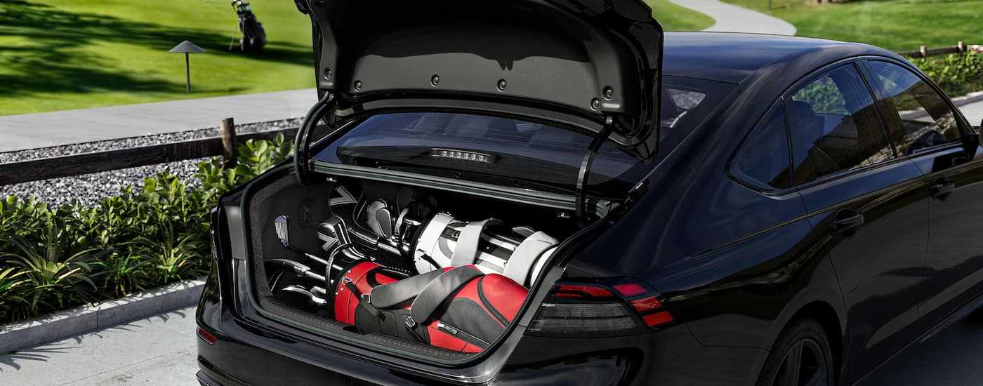 A set of golf clubs are in the trunk of a 2024 Honda Accord Sport-L Hybrid.